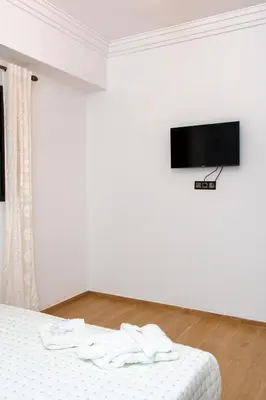 a bedroom with a bed with a tv on the wall at Appartement Duplex Hivernage in Marrakech