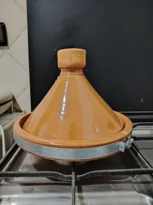 a large copper pot sitting on top of an oven at Quiet and family apartment, appartement in Marrakech