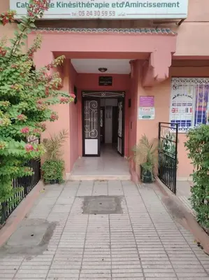 an entrance to a pink building with a door at Quiet and family apartment, appartement in Marrakech