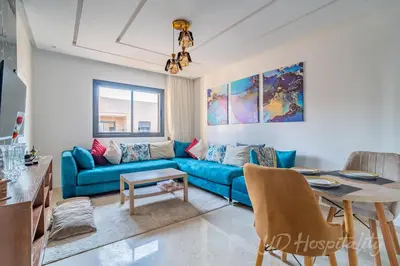 a living room with a blue couch and a table at 5-Star Suite in Prime Spot with Luxe Touches in Marrakech