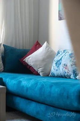 a blue couch with pillows on top of it at 5-Star Suite in Prime Spot with Luxe Touches in Marrakech