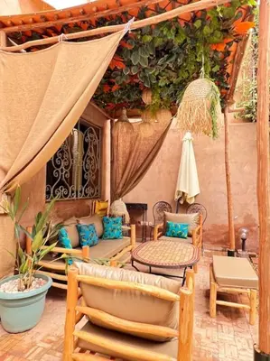 a patio with a tent and chairs and a table at Villa M à Marrakech in Marrakech