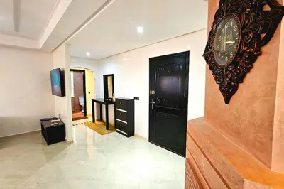 a room with a clock on the wall and a hallway at Amazing view, apartment in Marrakech in Marrakech