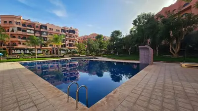 a swimming pool in front of a building at Amazing view, apartment in Marrakech in Marrakech