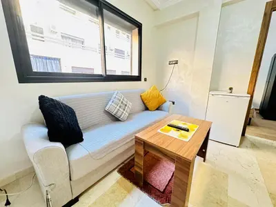 a living room with a couch and a table at Appartement au centre de Gueliz, hivernage in Marrakech