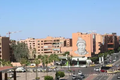 a city with a large mural of a man on a building at Appartement au centre de Gueliz, hivernage in Marrakech