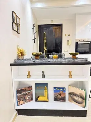 a white shelf with pictures on it in a room at Appart au Cœur de Gueliz in Marrakech