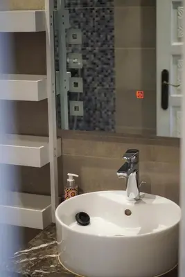 a white sink in a bathroom with a mirror at Suite Majorelle - Luxe-Terasse-Parking privée in Marrakech
