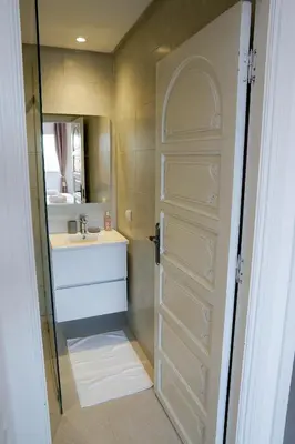 a bathroom with a sink and a mirror and a door at Suite Majorelle - Luxe-Terasse-Parking privée in Marrakech
