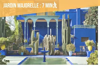 a blue building with a fountain and cactus at Suite Majorelle - Luxe-Terasse-Parking privée in Marrakech