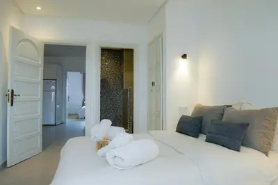a white bed with towels on it in a room at Suite Majorelle - Luxe-Terasse-Parking privée in Marrakech