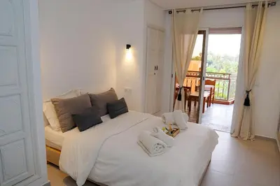 a bedroom with a white bed with towels on it at Suite Majorelle - Luxe-Terasse-Parking privée in Marrakech
