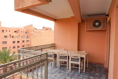 a balcony with a table and chairs on it at Suite Majorelle - Luxe-Terasse-Parking privée in Marrakech