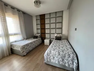 a bedroom with two beds and a window at Appartement de luxe Prestigia in Marrakech