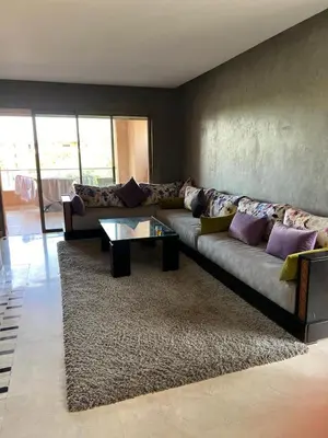 a living room with a couch and a coffee table at Appartement de luxe Prestigia in Marrakech