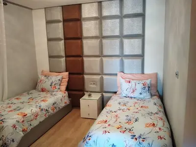 a bedroom with two beds and a window at Appartement de luxe Prestigia in Marrakech