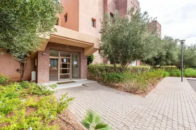 a building with a sidewalk in front of a building at Stunning Prestigia Escape Poolside Views in Marrakech