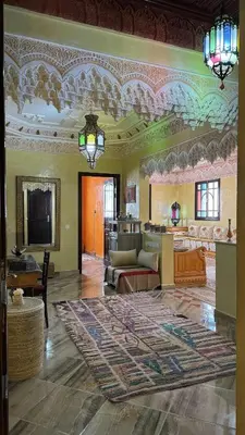 a large living room with a large rug on the floor at Dar Yamna Maison d'Hôtes in El Gouassem