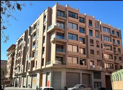 a large building with cars parked in front of it at Élégance urbaine, Gueliz central in Marrakech