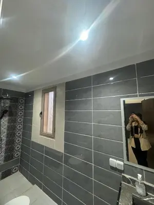 a person taking a picture in a bathroom mirror at Villa S in Marrakech