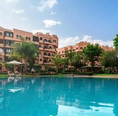 a large swimming pool in front of a building at appartement Nizar in Marrakech