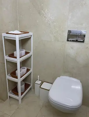 a bathroom with a white toilet in a room at Chambre de luxe avec piscine in Marrakech