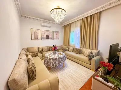 a living room with a couch and a table at Luxoria Home - Pool & 3 min To Gueliz in Marrakech