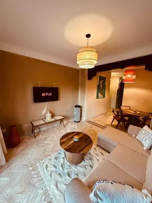 a living room with a couch and a table at Dar Celya Sfia in Marrakech