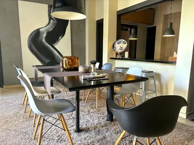 a dining room with a black table and chairs at Palais Bali in Marrakech