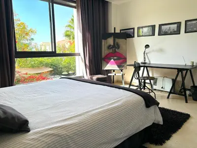 a bedroom with a bed and a desk and a window at Palais Bali in Marrakech