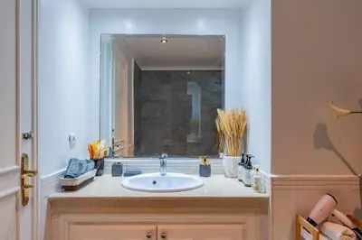 a bathroom with a sink and a mirror at Piscine Hivernage plein Centre in Marrakech