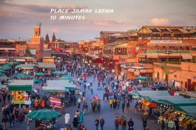 a crowd of people walking through a market with buildings at Tulipe Family House-Pool and Parking in Marrakech