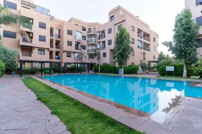 a swimming pool in front of a building at Duplex with private pool in Marrakech