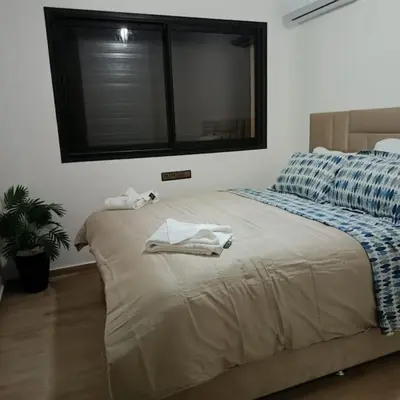 a bedroom with a bed with two towels on it at superbe appartement à côté de la gare à Gueliz Marrakech in Marrakech