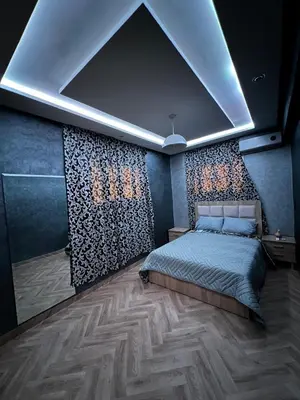 a bedroom with a bed in a room with a wall at Cozy Apartment near airport in Marrakech