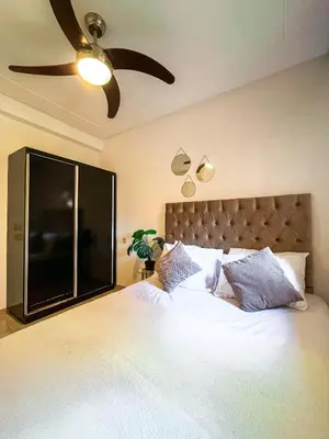 a bedroom with a large bed with a large television at Élégant appart 3 chambres cozy avec piscine in Marrakech