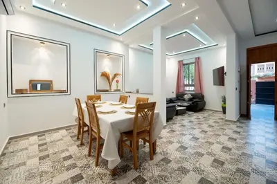 a dining room with a white table and chairs at Villa Targa in Marrakech