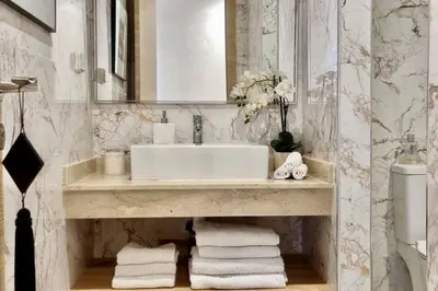 a bathroom with a sink and a pile of towels at Charming apartment in Agdal in Marrakech