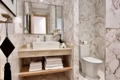 a bathroom with a sink and a toilet and a mirror at Charming apartment in Agdal in Marrakech