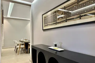 a dining room with a table and a picture on the wall at Apartment in the heart of Marrakech in Marrakech