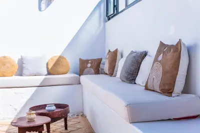 a room with a couch with pillows and a table at Riad Orb Private Riad Breakfast Included in Marrakech