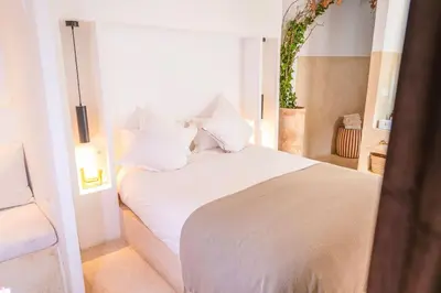 a white bed with white pillows in a room at Riad Orb Private Riad Breakfast Included in Marrakech