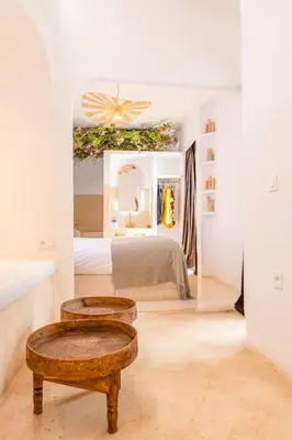 a bedroom with a bed and two tables in it at Riad Orb Private Riad Breakfast Included in Marrakech