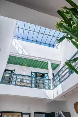 a building with a balcony with blue railing at Riad Orb Private Riad Breakfast Included in Marrakech