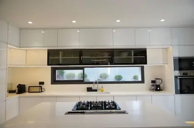a kitchen with white cabinets and a counter top at Marrakech Oasis Retreat - 5-Bedroom Villa with Private Pool in El Makina