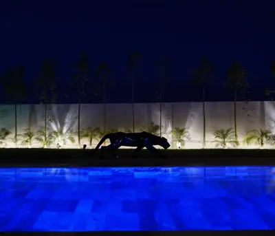a painting of a lion walking by a pool at night at Marrakech Oasis Retreat - 5-Bedroom Villa with Private Pool in El Makina
