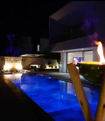 a swimming pool in front of a building at night at Marrakech Oasis Retreat - 5-Bedroom Villa with Private Pool in El Makina