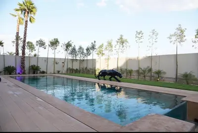 a elephant walking in the water in a swimming pool at Marrakech Oasis Retreat - 5-Bedroom Villa with Private Pool in El Makina