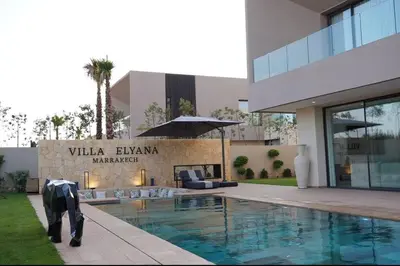 a building with a swimming pool in front of a building at Marrakech Oasis Retreat - 5-Bedroom Villa with Private Pool in El Makina