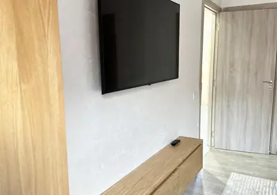 a flat screen tv on a wall in a room at Sérénité au coeur de Marrakech in Marrakech
